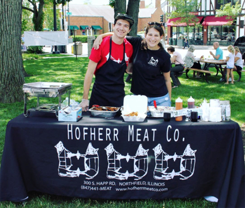 Two Hofherr Meat employees working at a catered event