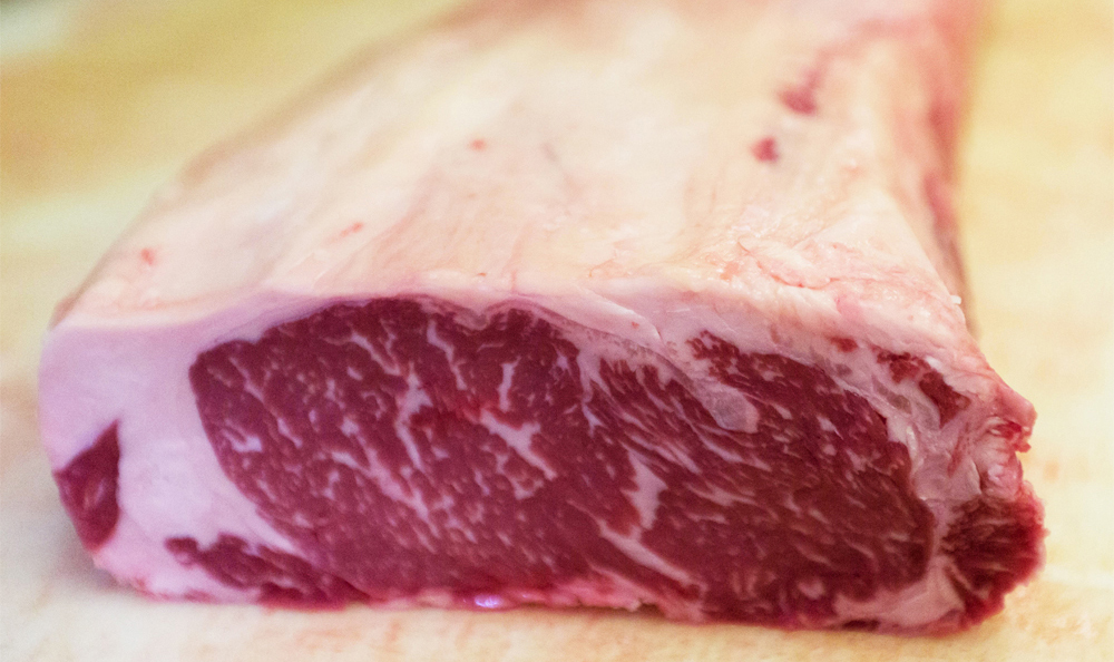 Cut of a raw marbled steak