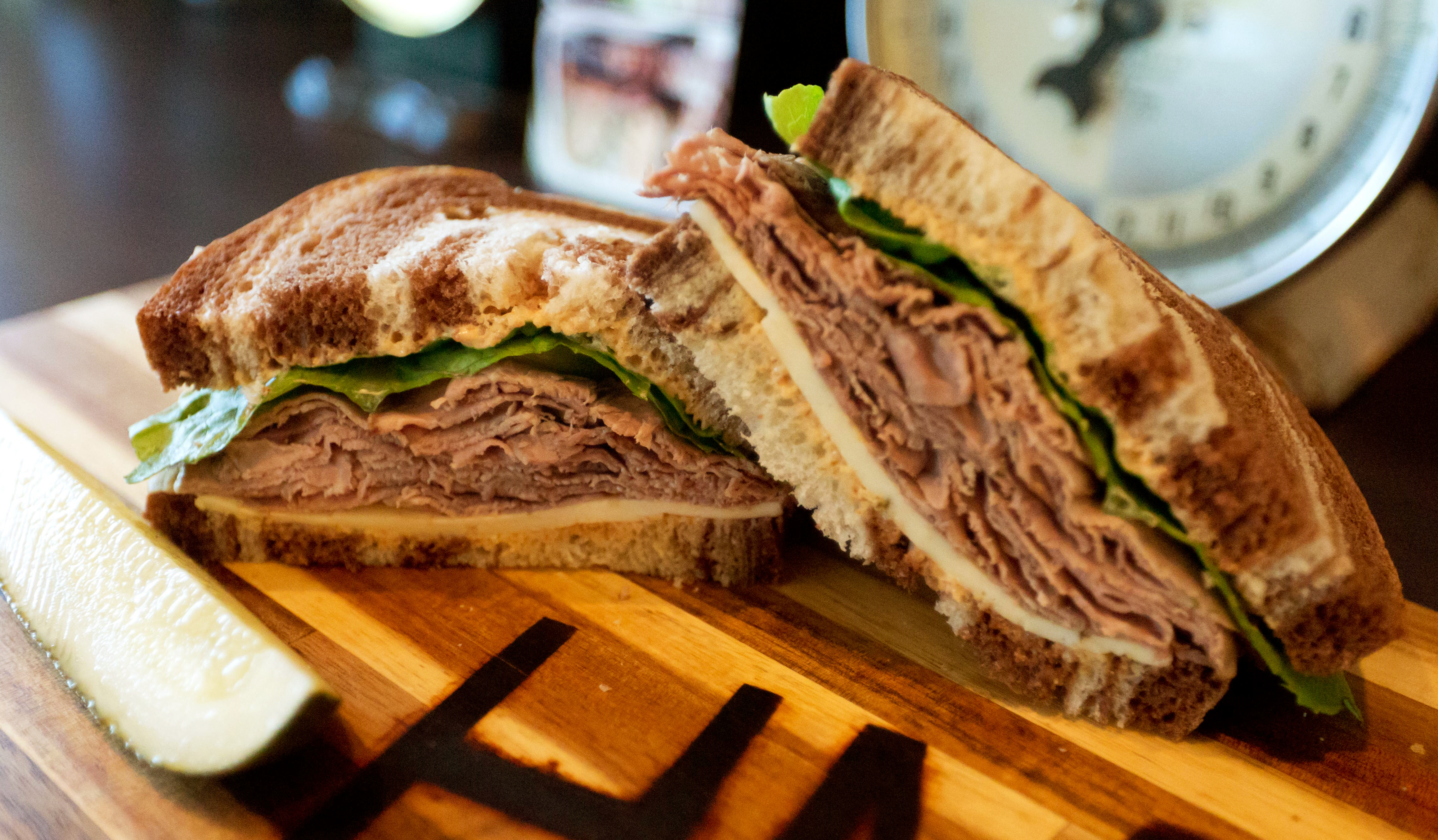 Corned beef sandwich on marble rye, with a pickle spear
