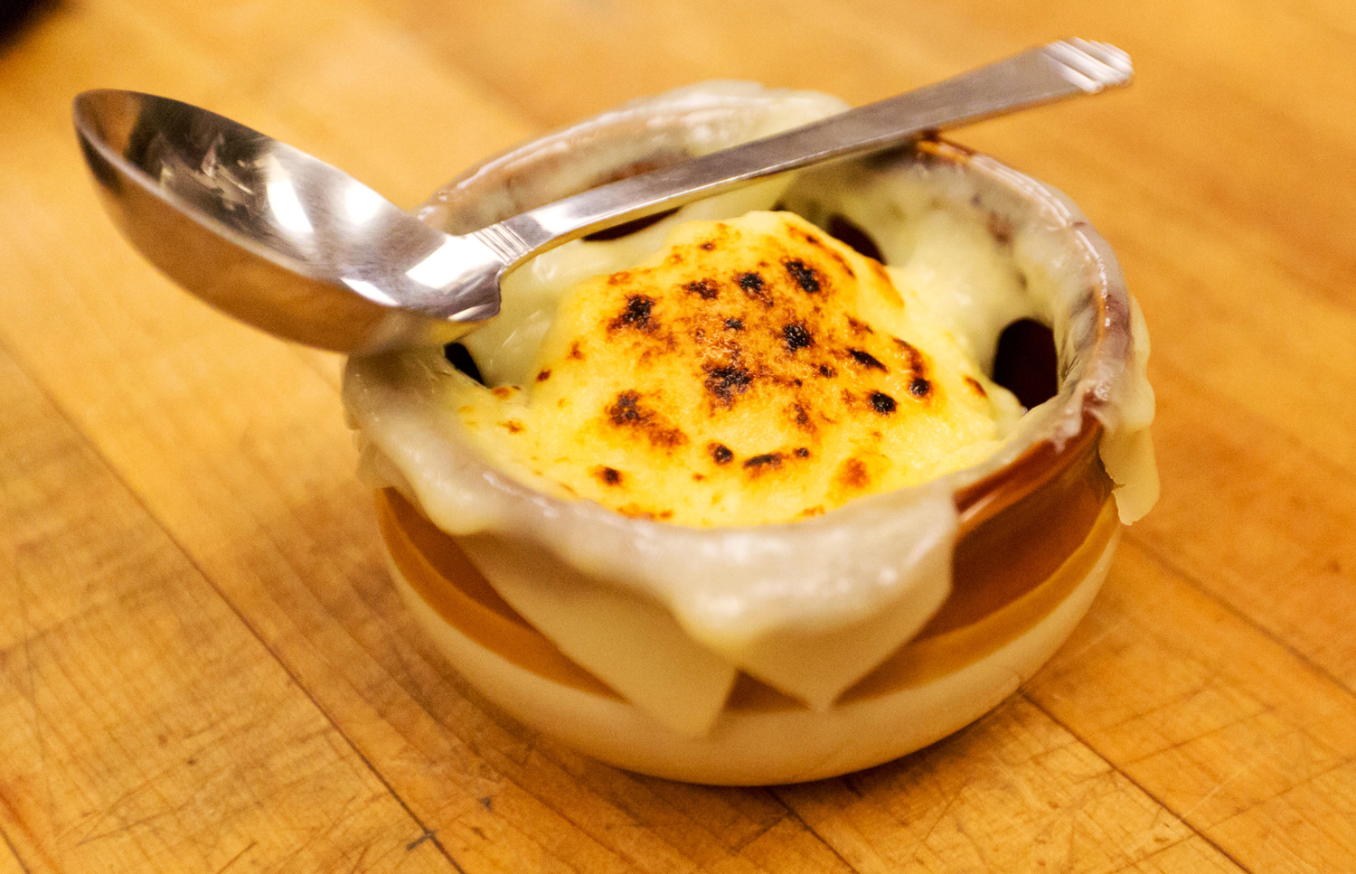 Crock of French onion soup with melted cheese