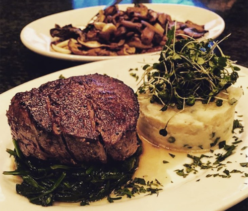 Filet mignon dinner with mashed potatoes and a mushroom platter
